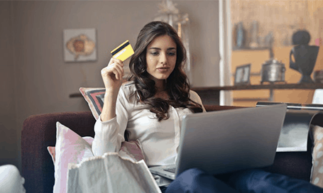 Woman holding credit card ready to purchase online order